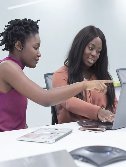 Two finance professionals reviewing the accounts receivable team's Days Sales Outstanding (DSO) metrics on a tablet in a conference room.